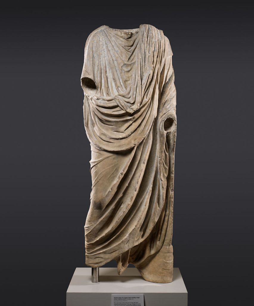 Headless statue of man wearing a toga